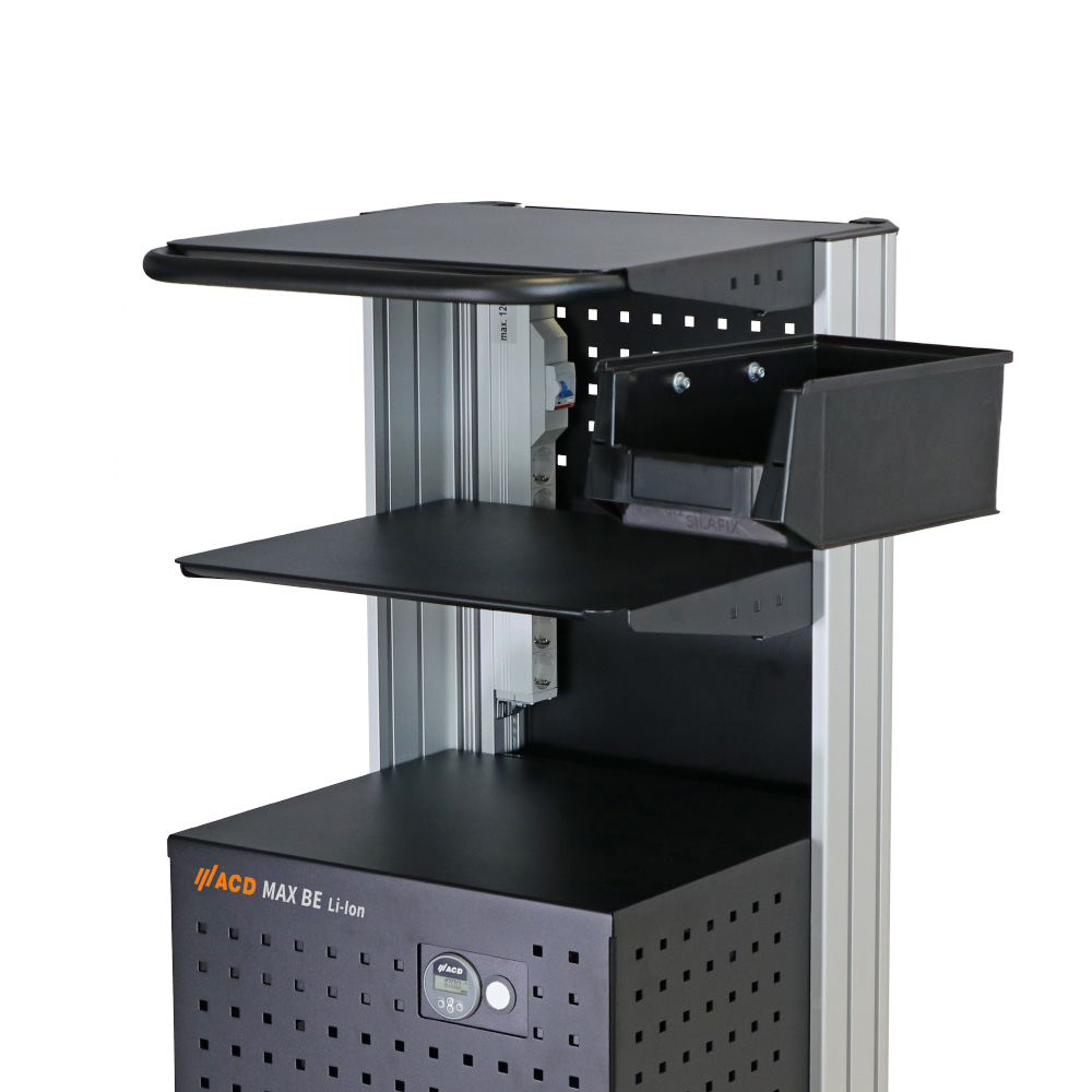 The lateral storage box consists of a sturdy plastic box and a mounting bracket. The storage box is attached to the side of the frame of the mobile workstation.